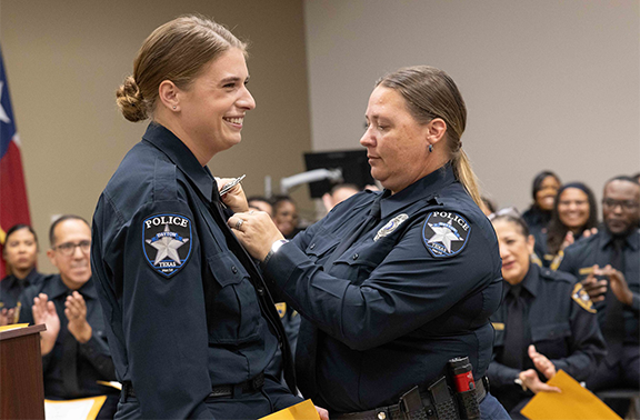 Newly minted Officer Emma Clary receives her badge.